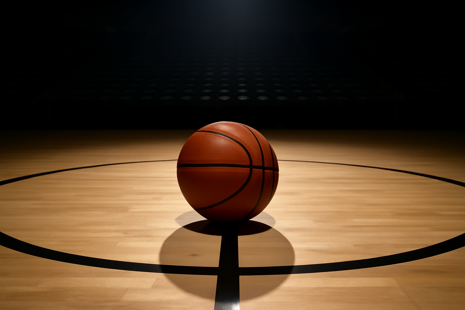 A WNBA basketball resting on a hardwood court under arena lights