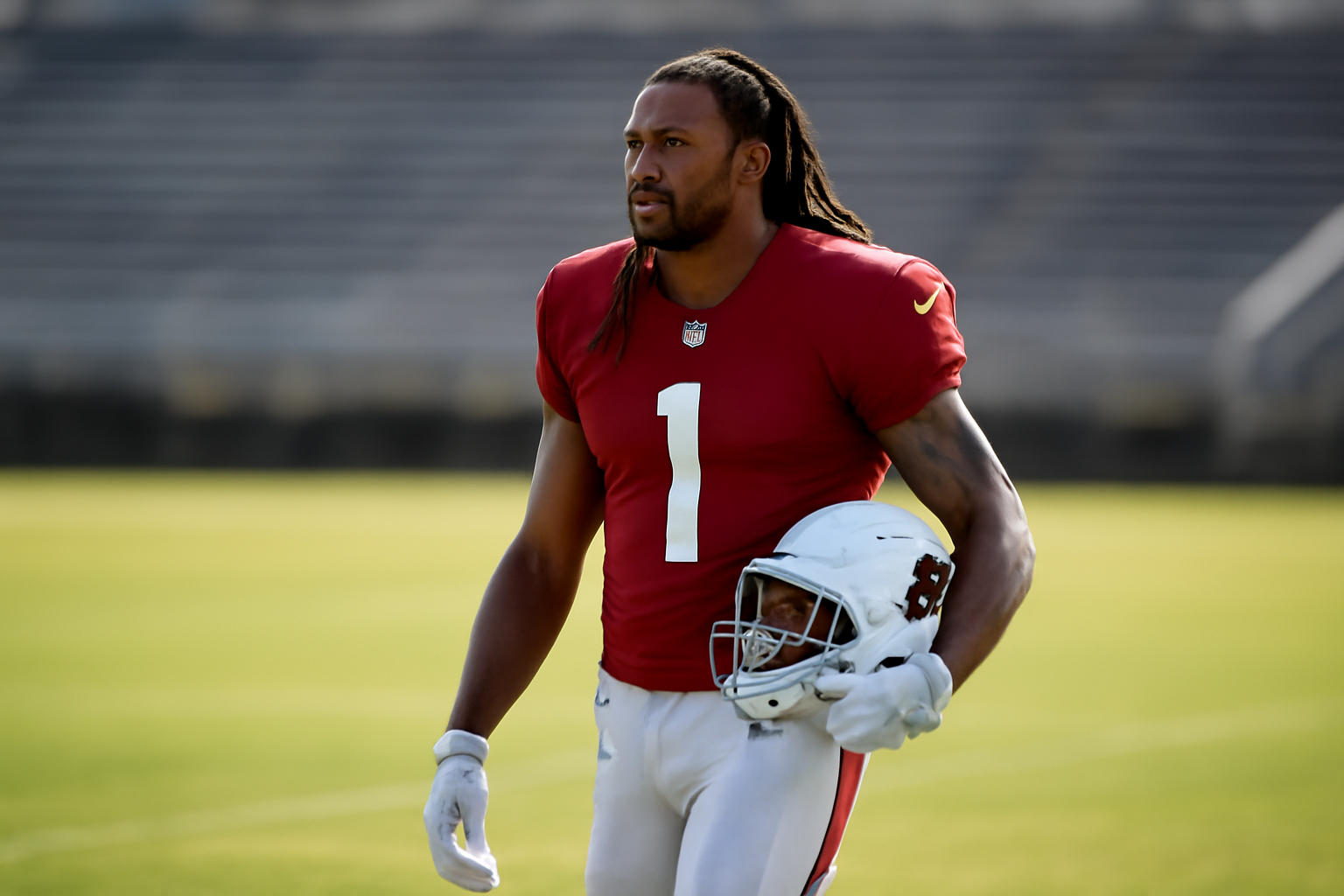 Arizona Cardinals wide receiver standing alone on a practice field in team uniform