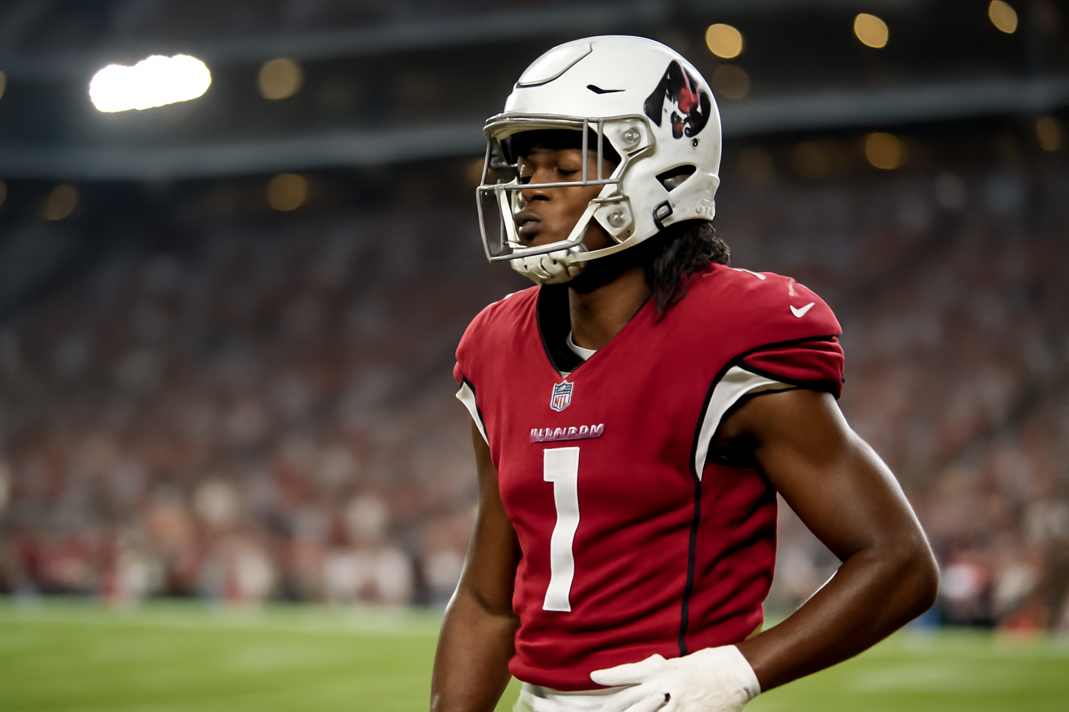 NFL wide receiver in Arizona Cardinals uniform standing on the sideline before a game