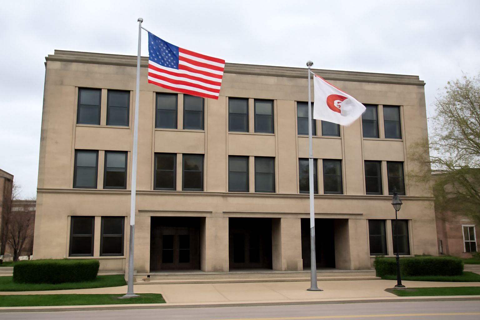 Memphis city hall exterior with the Tennessee state flag and American flag flying under a clear sky